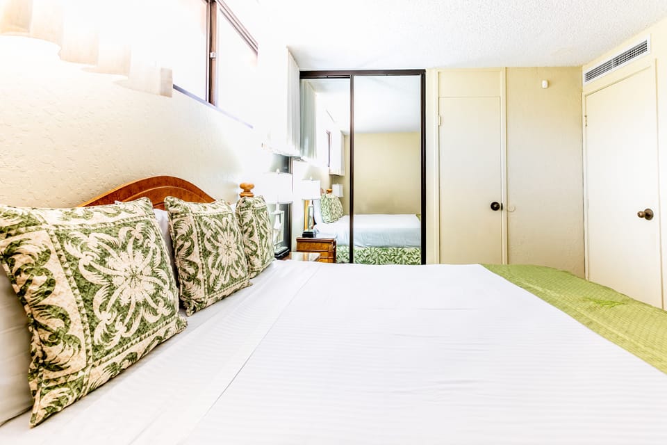 Sink into crisp linens and tropical green accents in your bright bedroom, complete with climate control and a peaceful adjoining space for restful nights.