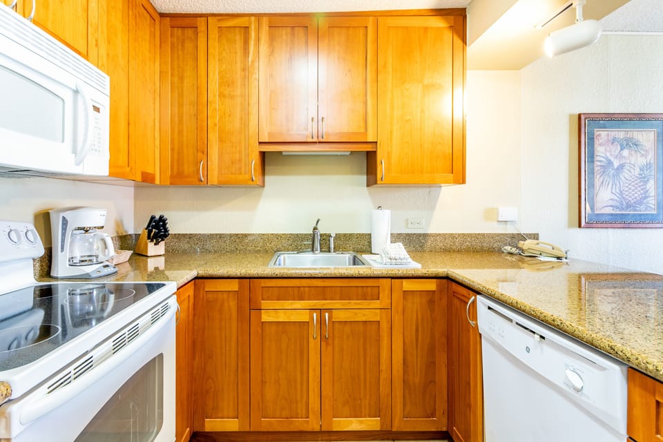 Your fully equipped kitchen features warm wood cabinetry, granite countertops, and everything you need to prepare meals during your stay, including a stove, microwave, and dishwasher.