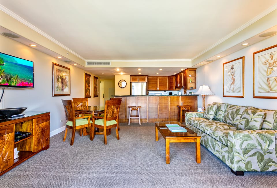 Step into your spacious tropical retreat featuring a bright, open living and dining area. Rich wood furnishings and lush botanical décor create a relaxing island atmosphere where you can unwind and feel right at home.