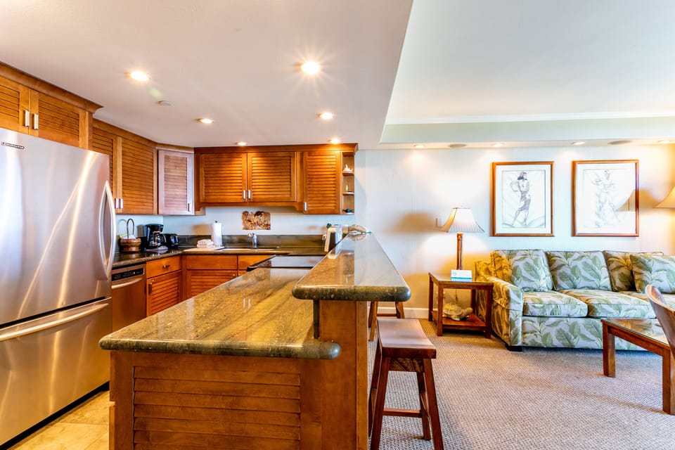 Your spacious open-concept suite blends a fully equipped kitchen with granite counters and stainless appliances alongside a bright living area, perfect for unwinding after island adventures.