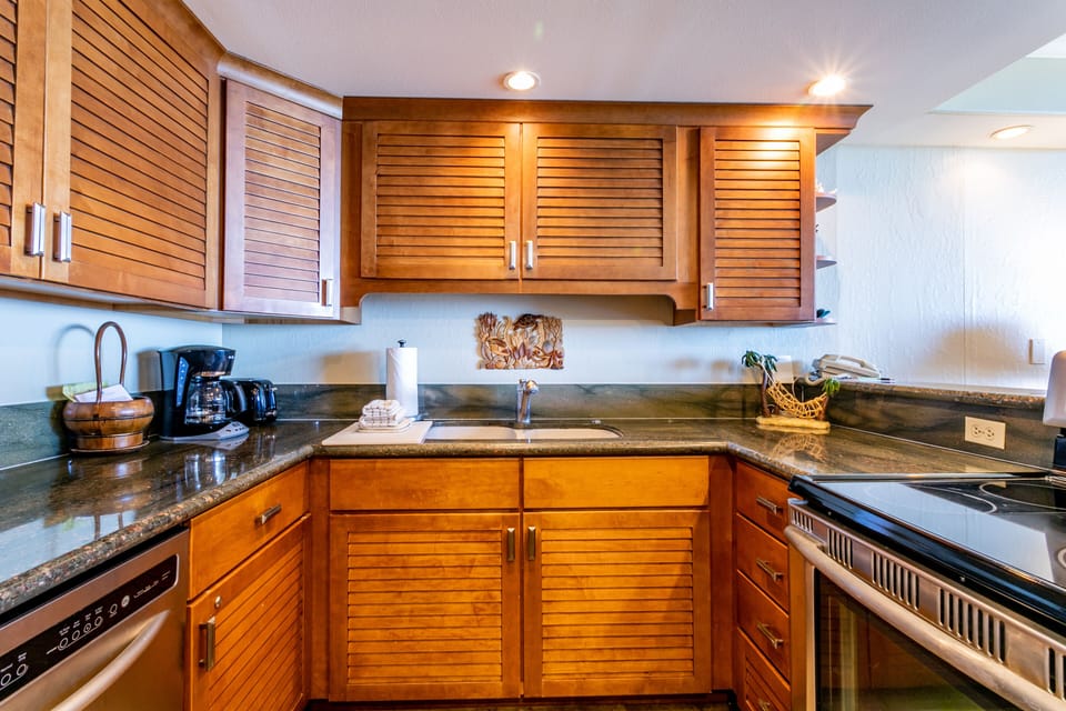 Your fully equipped kitchen awaits, with warm wood cabinetry, granite countertops, and all the essentials to prepare your favorite meals in comfort.