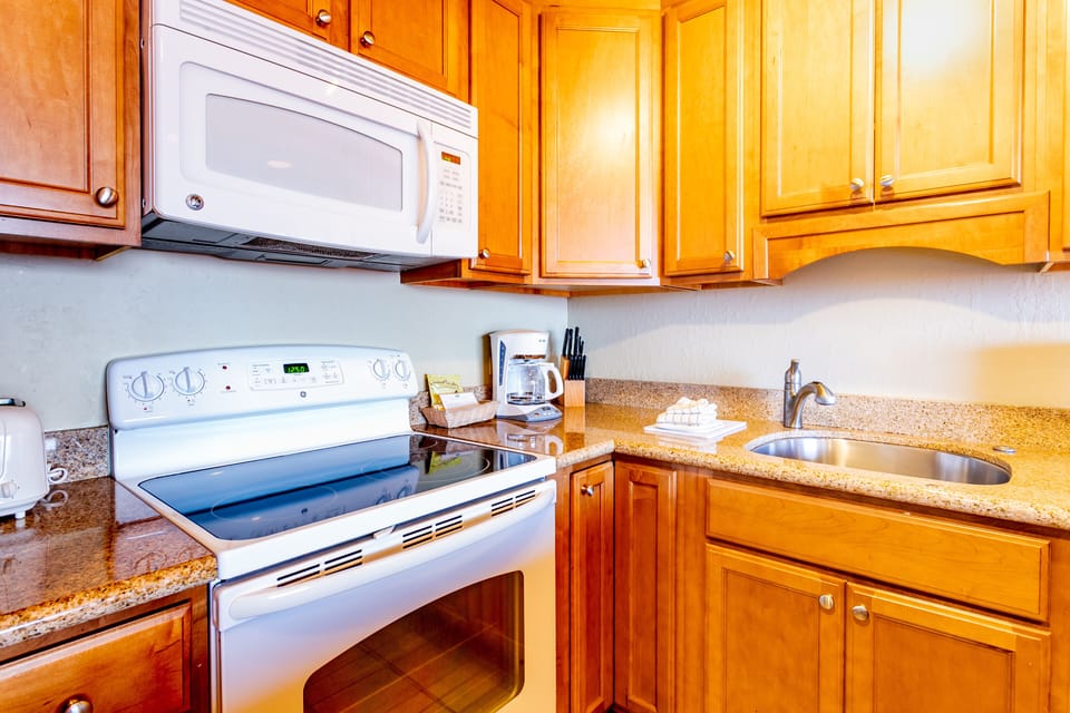 Cook your favorite meals in this fully equipped kitchen with modern appliances, ample counter space, and warm wood cabinetry—making your stay feel right at home.
