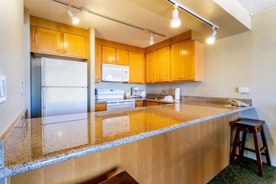 Prepare meals in your spacious kitchen with gleaming granite countertops, modern appliances, and ample cabinet space—a bright, inviting hub for gathering and creating memories.