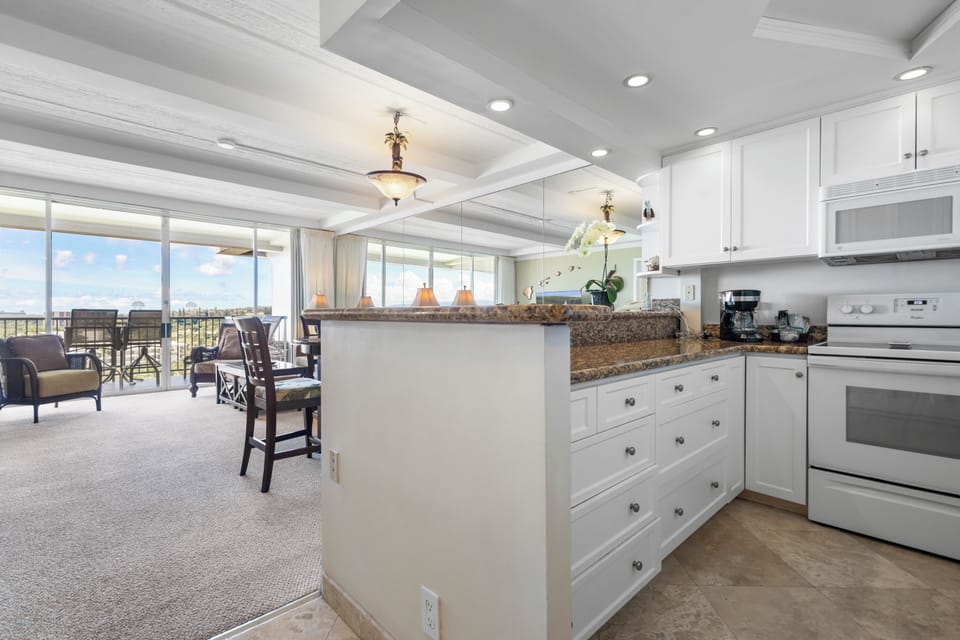 Bright open-concept living with a full kitchen flows seamlessly to your private balcony with sweeping views, perfect for morning coffee or relaxing as the day unfolds around you.