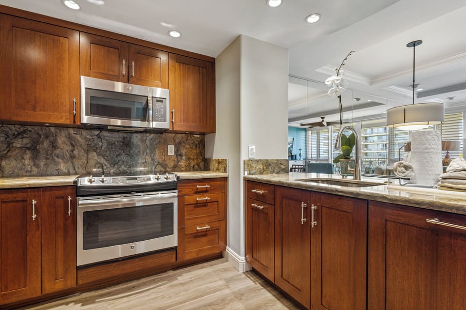 Your gourmet kitchen features rich wood cabinetry, granite countertops, and stainless steel appliances—everything you need to create memorable meals in style.