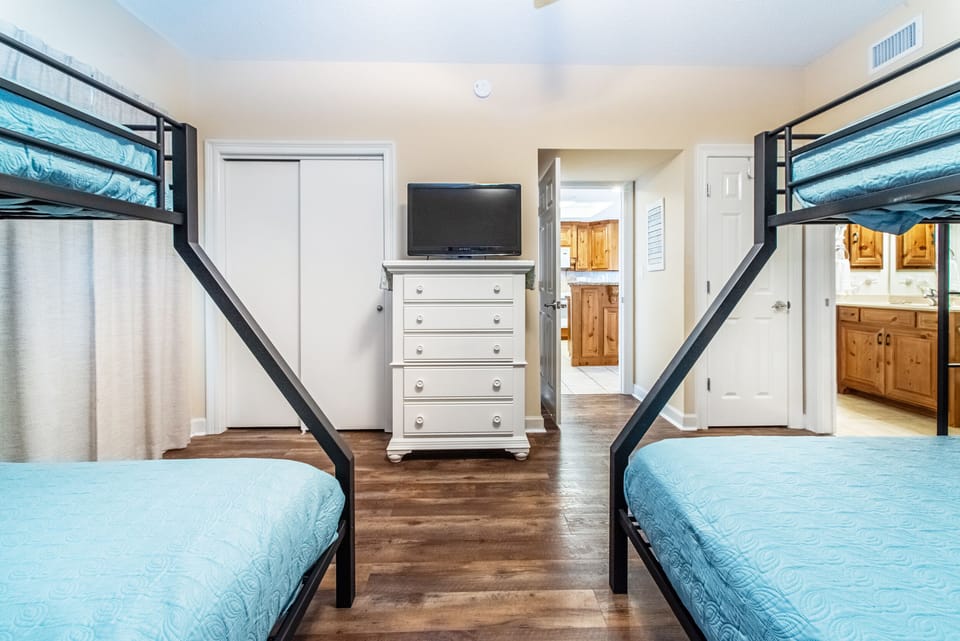 Bunk room with flat screen TV