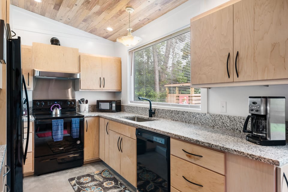 Fully custom kitchen with updated appliances and custom cabinets.