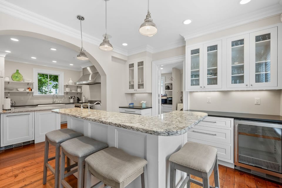 Chef's kitchen with gourmet range and ovens, Large farmer's sink, dishwasher, ample counter space.