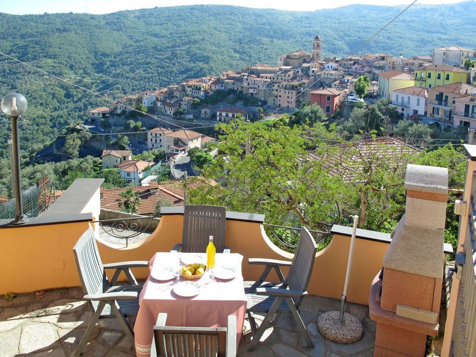 Table, Furniture, Sky, Building, Plant, Mountain, Flowerpot, Outdoor Furniture, Tree, Chair