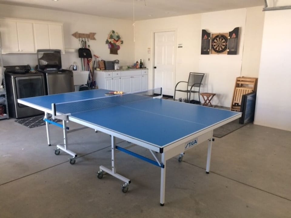 Garage game room with ping pong and darts
