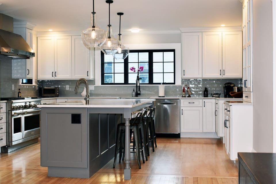 Chef kitchen with seating for four at counter.