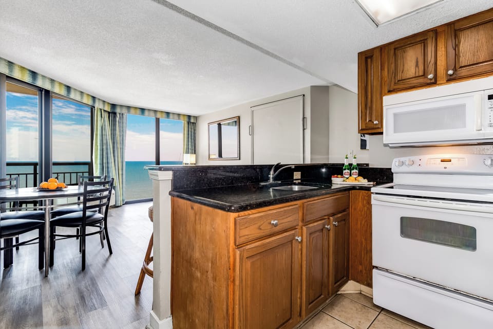 cooking in our suite's kitchen, where each meal preparation is accompanied by the ever-changing beauty of the ocean just outside the window.