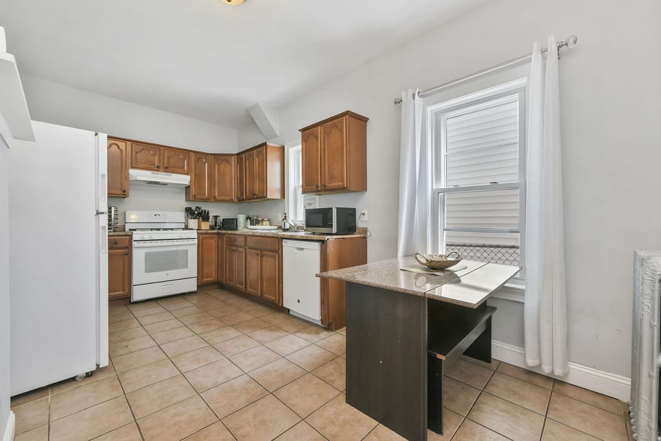 Kitchen, fully stocked with pots, pans, utensils, spices for cooking. 