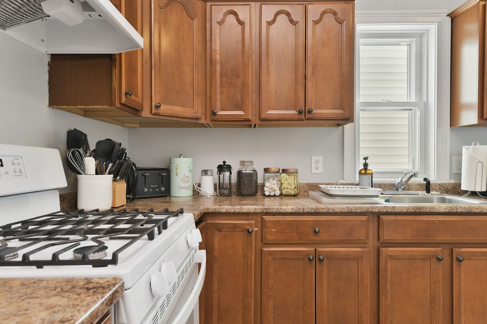 Kitchen, fully stocked with pots, pans, utensils, spices for cooking. 