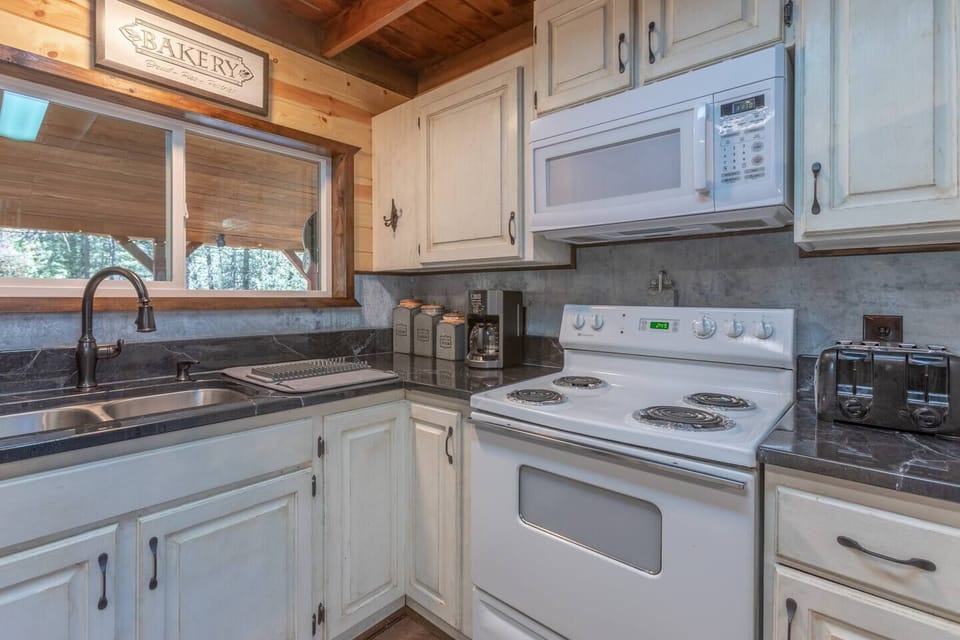 Enjoy meal cooking in this bright white spacious kitchen!
