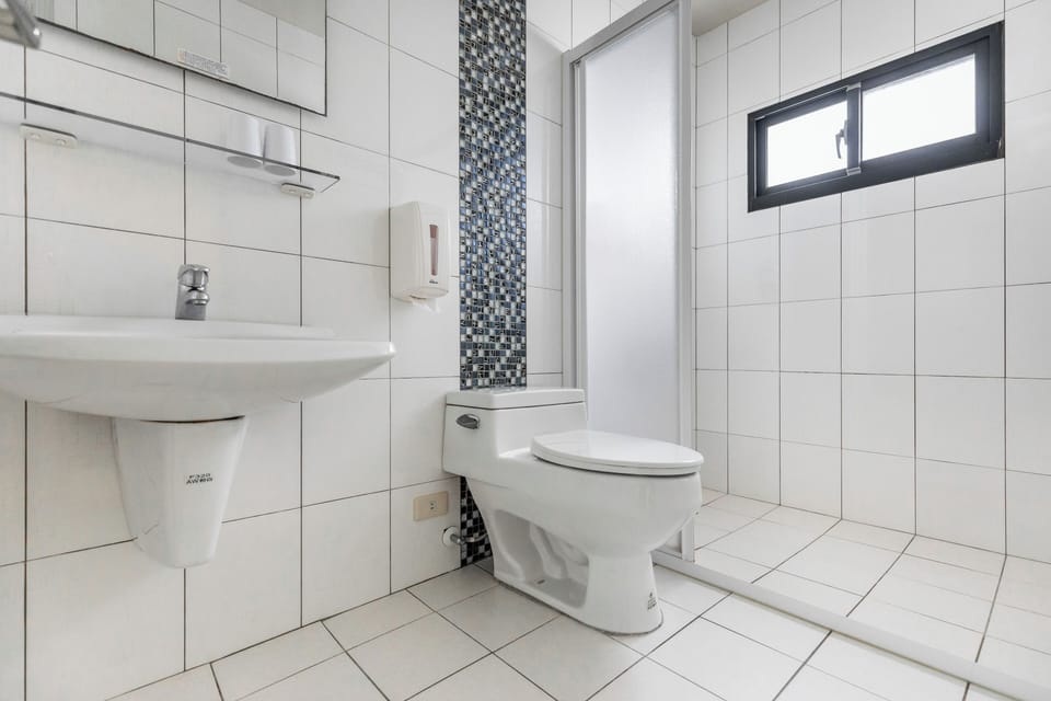 Shower, hair dryer, slippers, towels