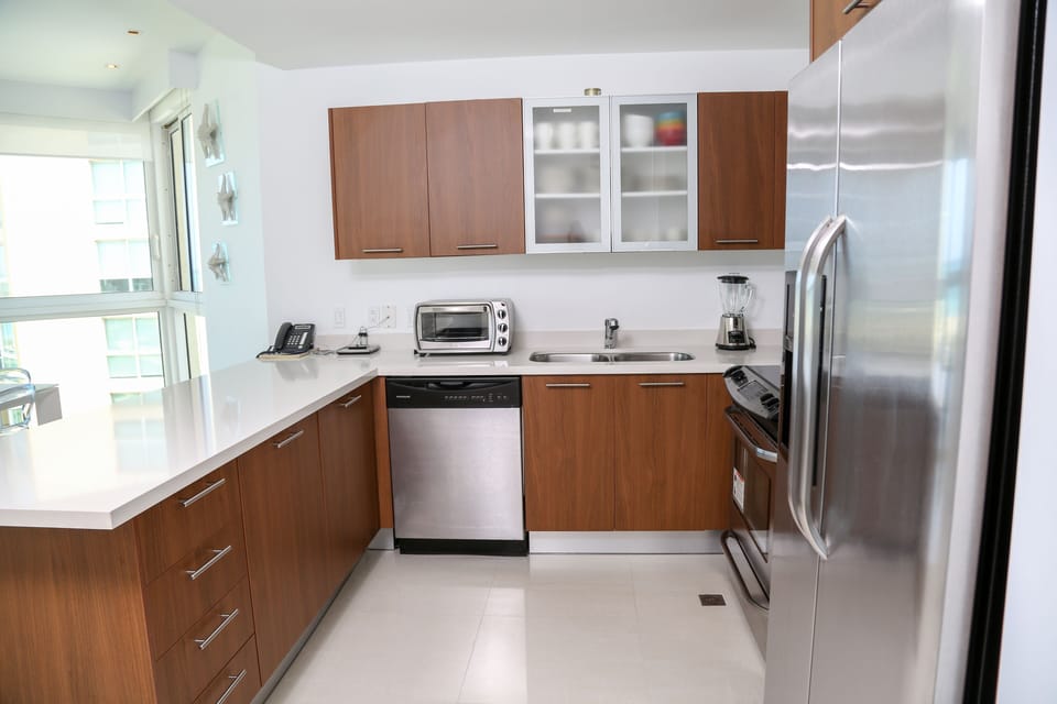 Your fully equipped kitchen features sleek stainless-steel appliances, ample counter space, and modern wood cabinetry—perfect for preparing meals with all the comforts of home.