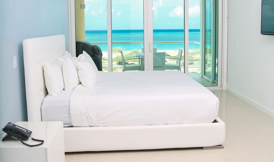 Wake up to breathtaking turquoise waters and soft white sand just steps from your private balcony. Your serene beachfront retreat awaits with fresh linens and stunning sea views.
