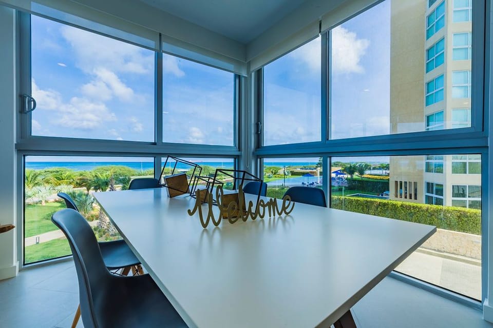 Your meals here overlook lush gardens, sparkling blue waters, and endless coastal horizons through floor-to-ceiling windows that flood the space with natural light and tropical breezes.