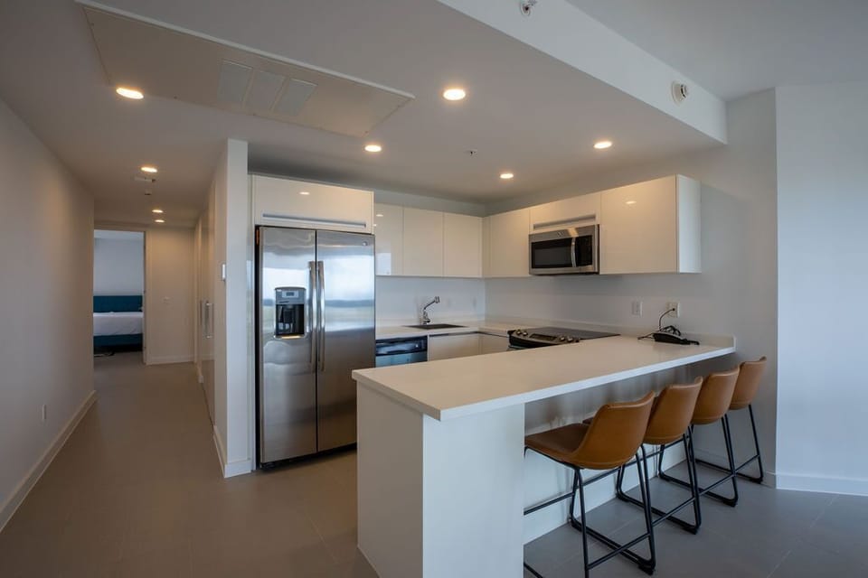 Your sleek, modern kitchen features stainless steel appliances, a breakfast bar with seating for casual meals, and clean lines that make meal prep effortless.