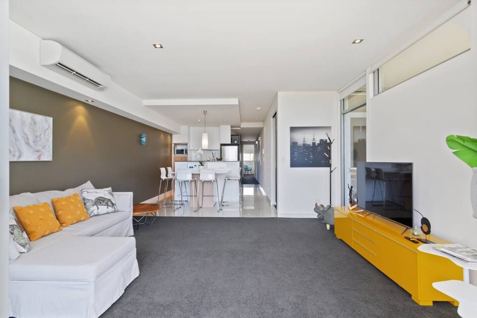 A stylish open-plan living area that effortlessly connects to the dining and kitchen zones, perfect for entertaining.
