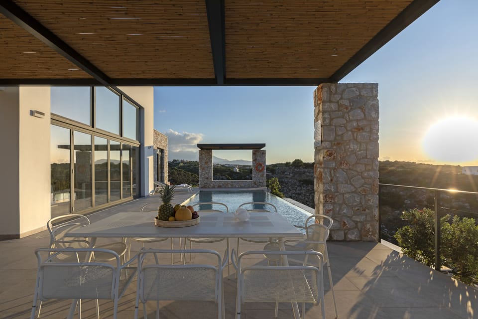 Outdoor dining and pool area by the breathtaking sunset