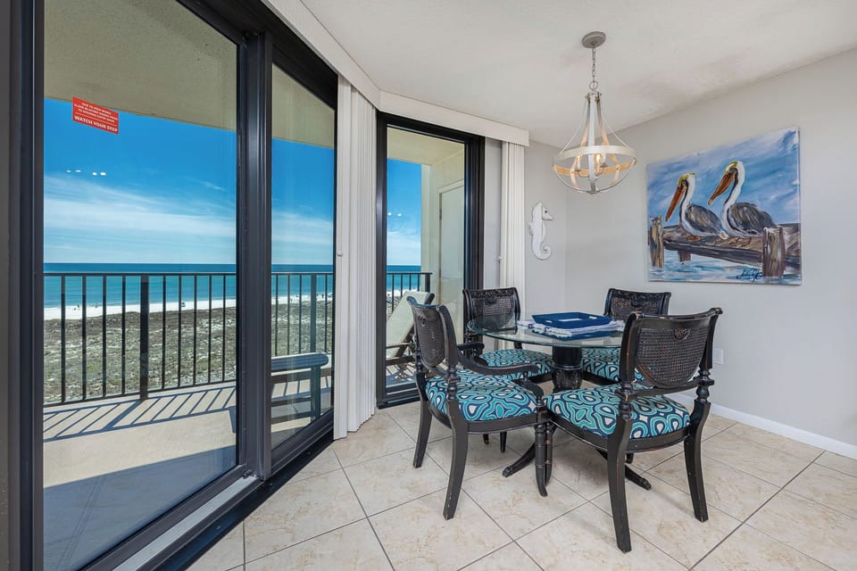 Gaze at the coast while enjoying a leisurely meal at your dining table, enveloped in beach decor