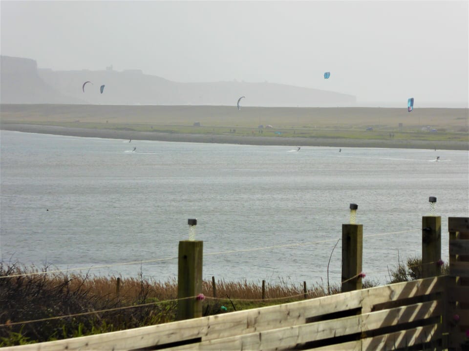 watching the kitesurfers from the garden on a cold, overcast day.