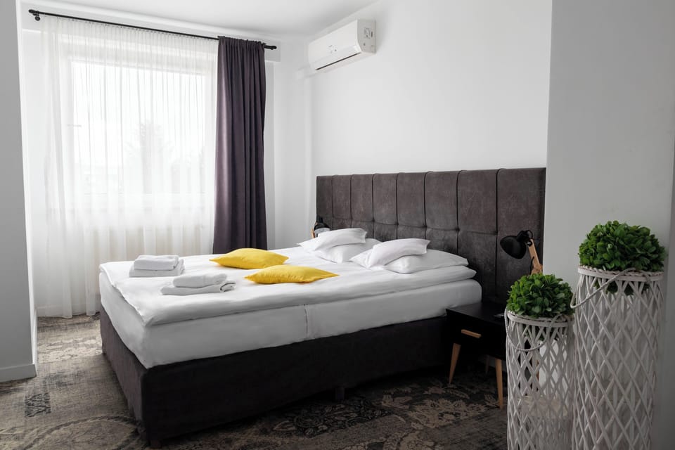 Deluxe Triple Room | Minibar, desk, laptop workspace, blackout drapes
