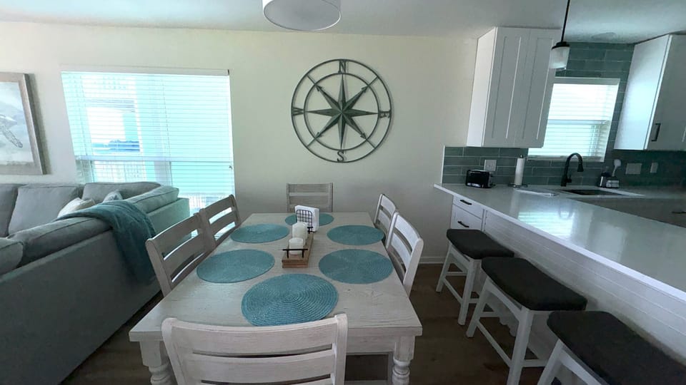Dining and kitchen with stools