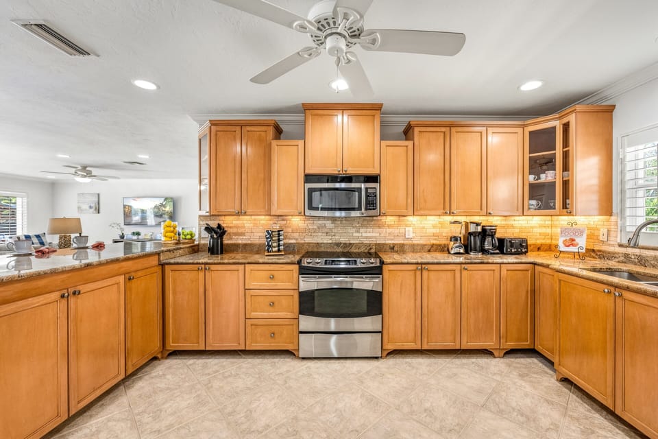 Prepare your favorite recipes with ease in the expansive kitchen featuring ample cabinetry and modern appliances.