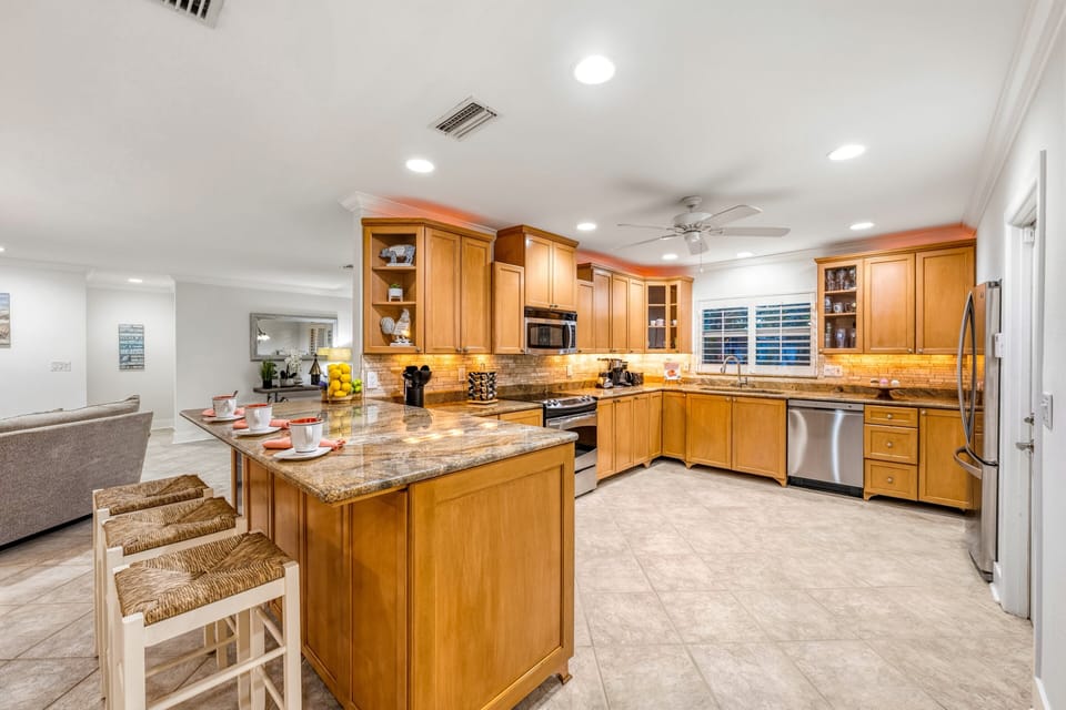 As the evening settles in, the beautifully lit kitchen becomes the perfect place to prepare dinner or gather for snacks.