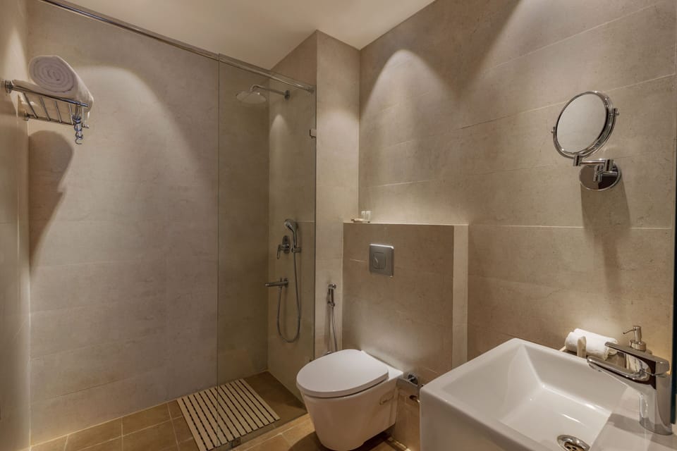 Shower, rainfall showerhead, slippers, towels