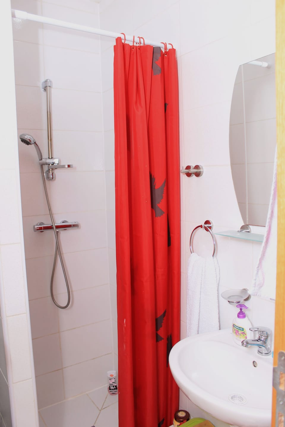 Shower, hair dryer, slippers, towels