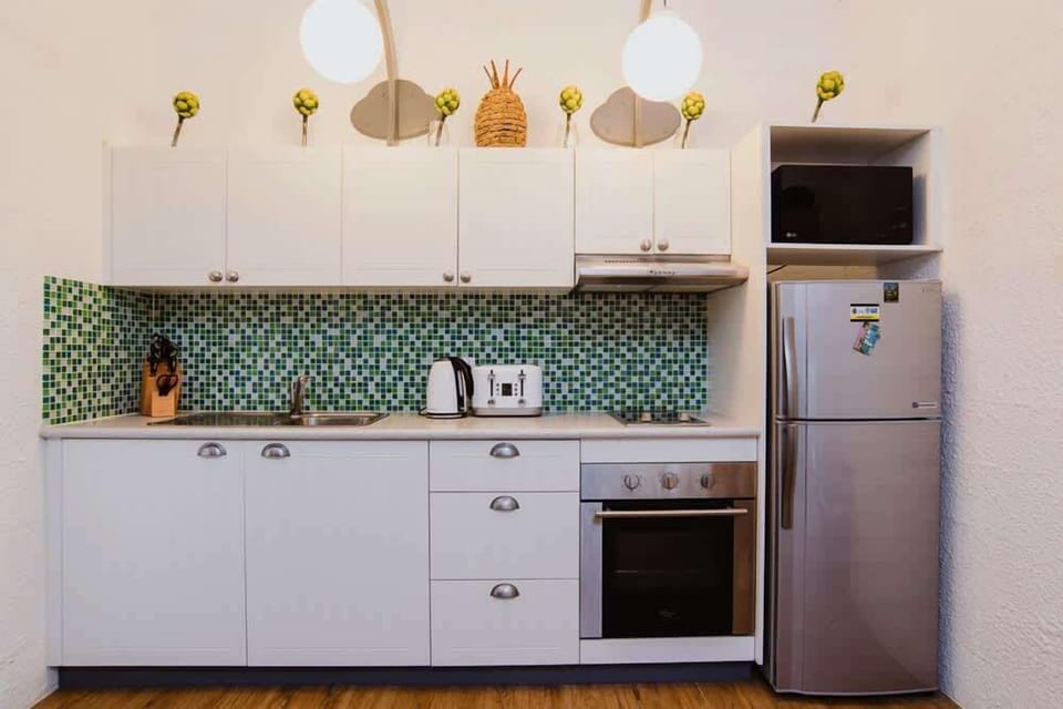 The compact kitchen is equipped with practical essentials, making it easy to prepare everything from morning coffee to simple home-cooked meals.