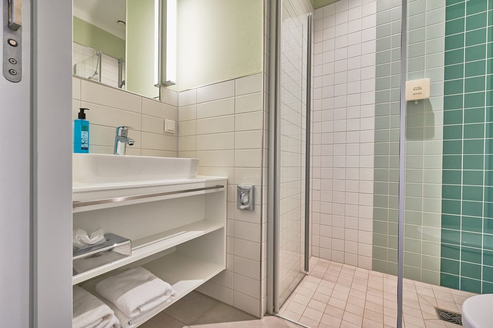 Economy Double Room | Bathroom | Shower, hair dryer, slippers, towels