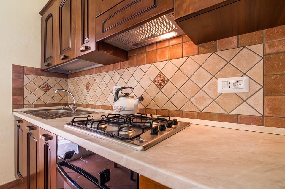 Apartment, 3 Bedrooms | Private kitchen | Full-size fridge, stovetop, cookware/dishes/utensils