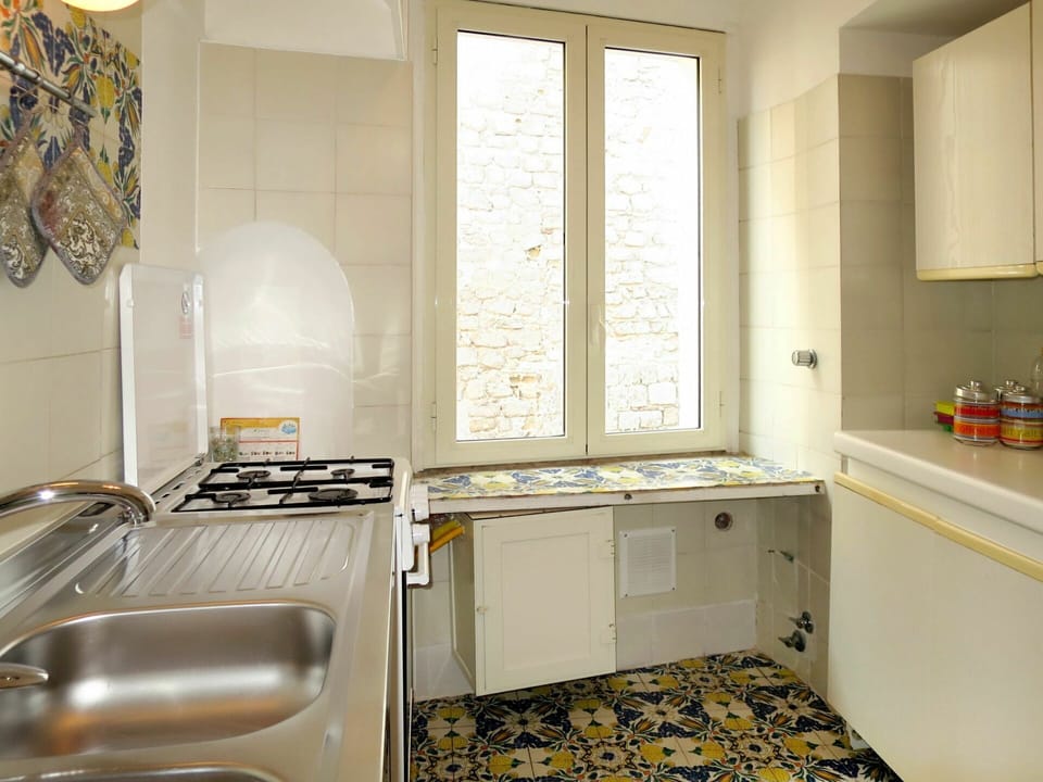 Room, Property, Furniture, Floor, Kitchen, Interior Design, Countertop, Yellow, Cabinetry, Building