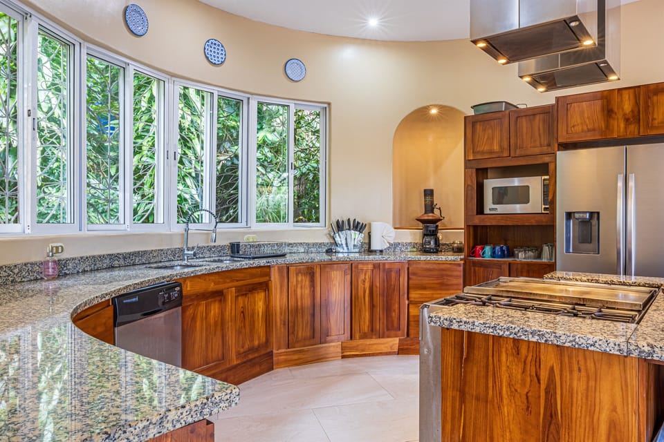 Curved counters and natural light create a warm, inviting cooking space