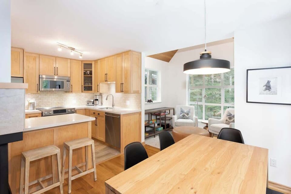 - Fully equipped kitchen with sleek modern appliances  
- Open-concept Whistler home blending comfort and style  
- Perfect dining area for family meals and mountain mornings  