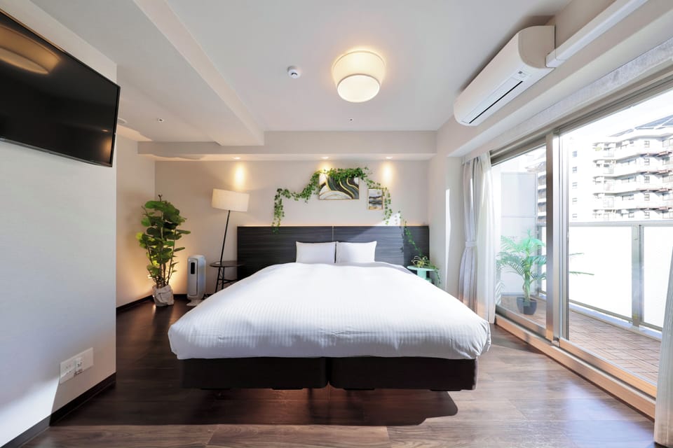 Deluxe Studio | Down comforters, desk, laptop workspace, blackout drapes