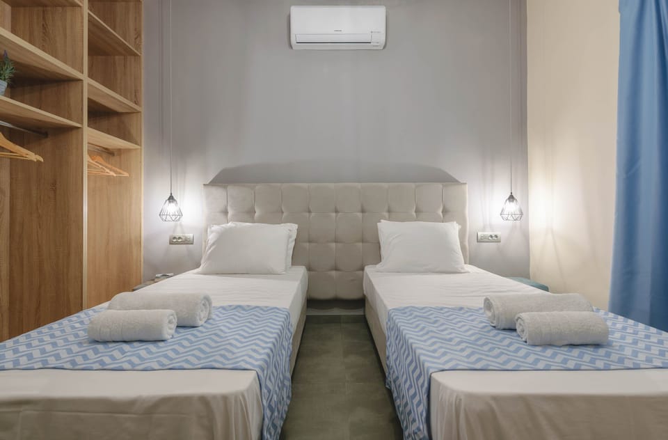 Triple Room, City View | In-room safe, iron/ironing board, free WiFi, bed sheets