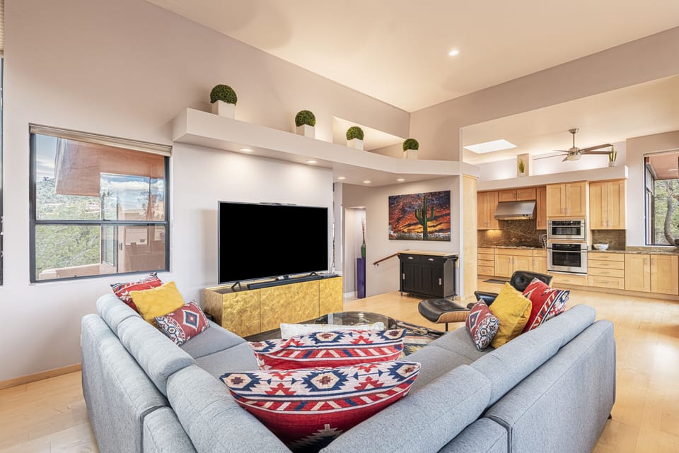 Great Room with Comfortable Furnishings, a 72" Smart TV with Sling TV, and Hardwood Floors