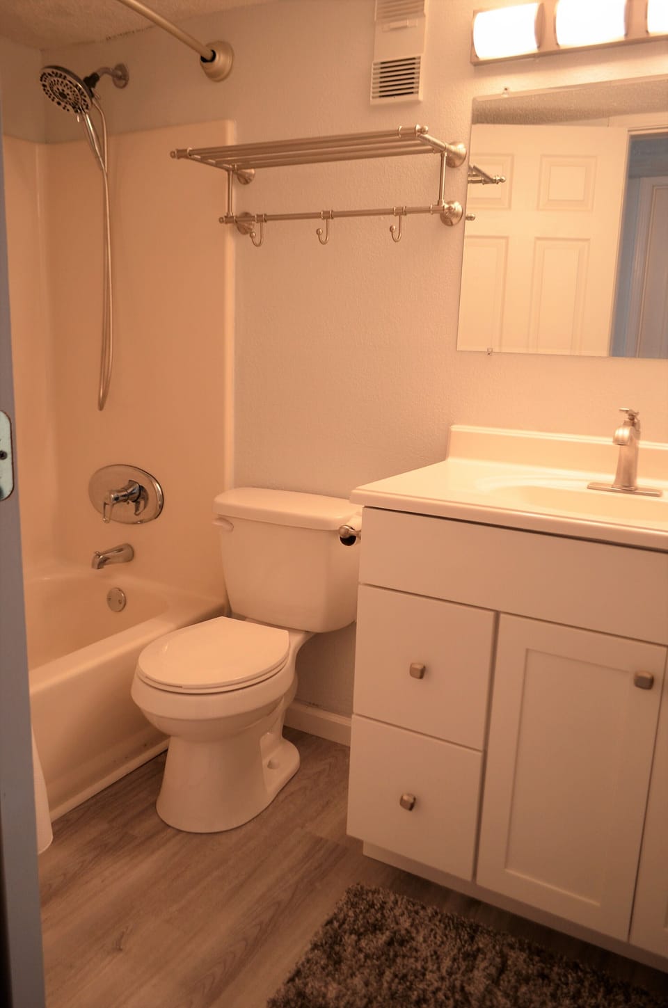 Bathroom features a single vanity and shower/tub combo.