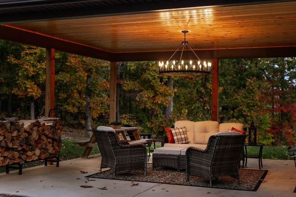 Relax under the covered patio with cozy seating and chandelier lighting