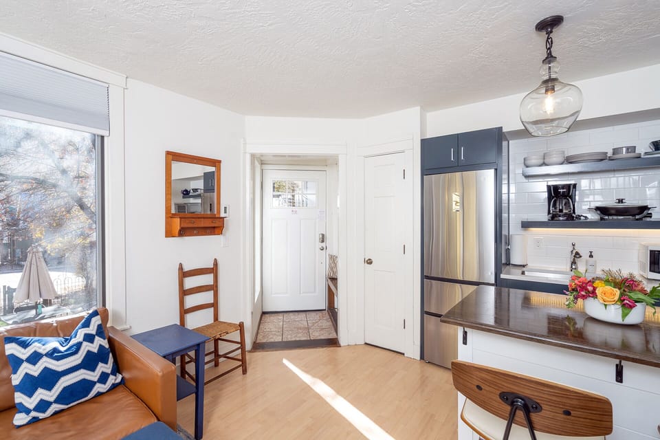 Enter this adorable space, there's a coat rack/bench on your left and into open space featuring the living area and kitchenette.