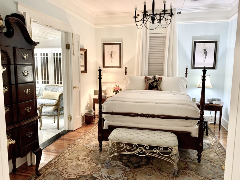 Front bedroom with queen bed, fan, highboy, cedar lined closet, chair 
& bench