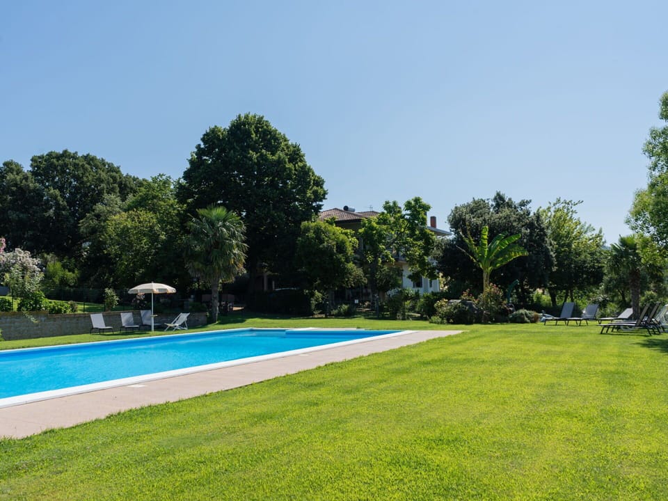Sky, Plant, Swimming Pool, Tree, Shade, Water, Rectangle, Building, Land Lot, Natural Landscape