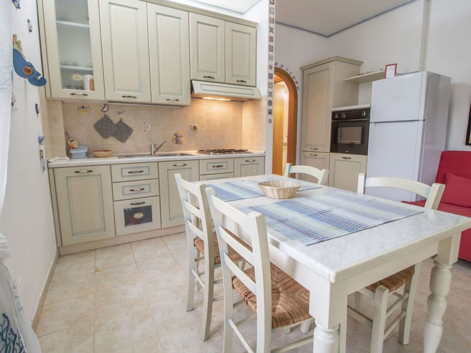Cabinetry, Furniture, Countertop, Table, Kitchen, Kitchen Sink, Kitchen Appliance, Chair, Refrigerator, Kitchen Stove