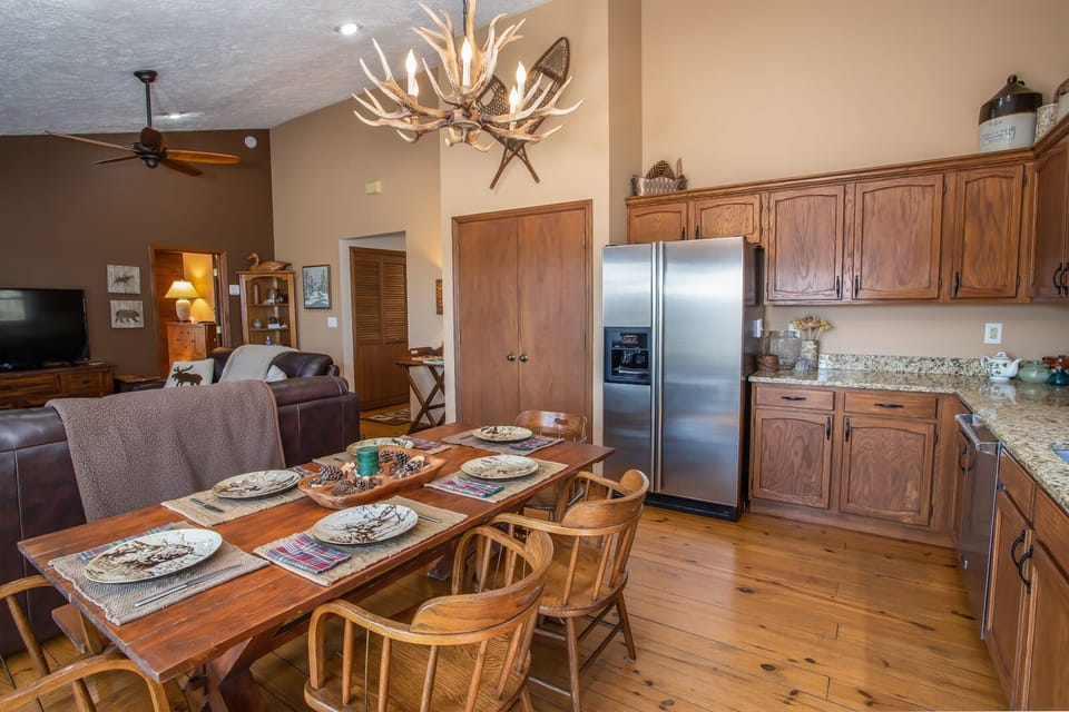 Banquet Style Dining table with Antler Chandelier Above